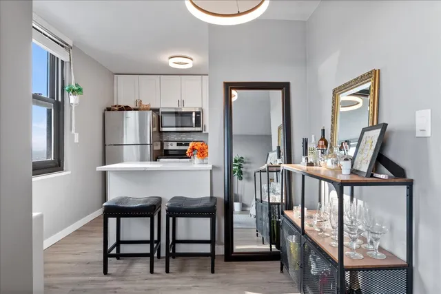 a dinning room with stainless steel appliances a table and chairs