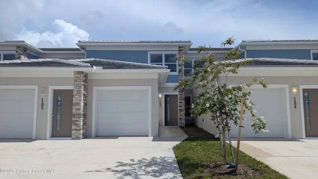 a view of a house with potted plants