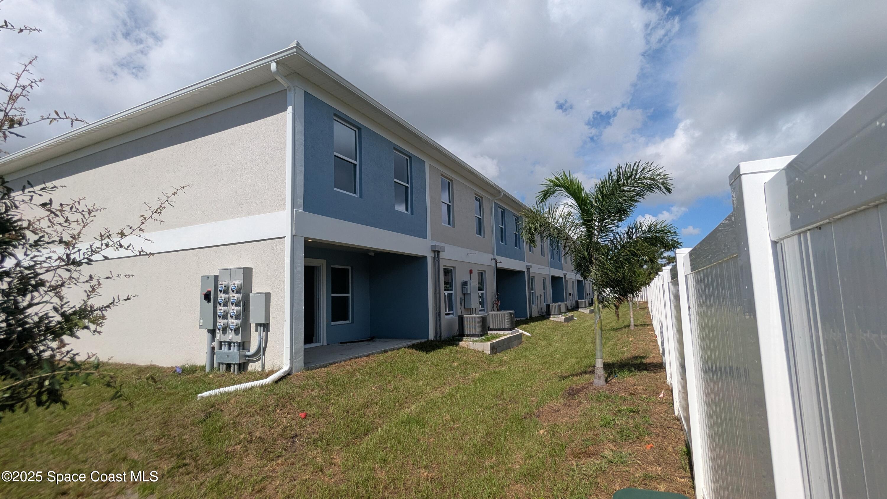 1625 Par Street, Unit 1105 Palm Bay, FL 32905 - Photo 30 of 32 a view of a house with a yard and potted plants