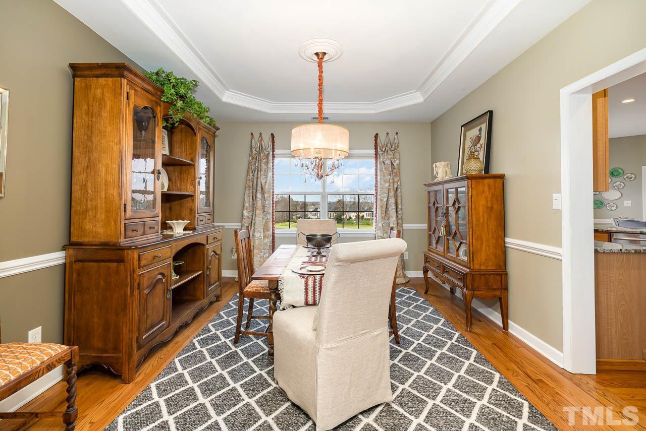 612 Seastone Street Raleigh, NC 27603 - Photo 7 of 41 a dining room with furniture a chandelier and window