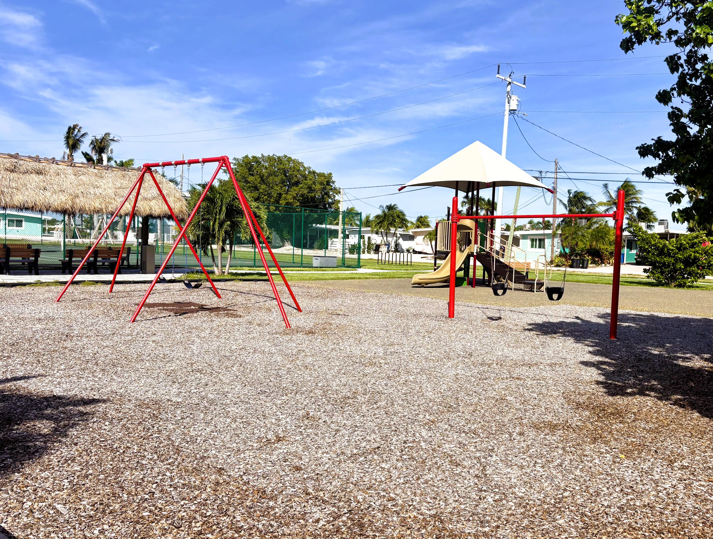 271 9th Street Key Colony Beach, FL 33051 - Photo 39 of 48 an outdoor space with lots of swings and slides