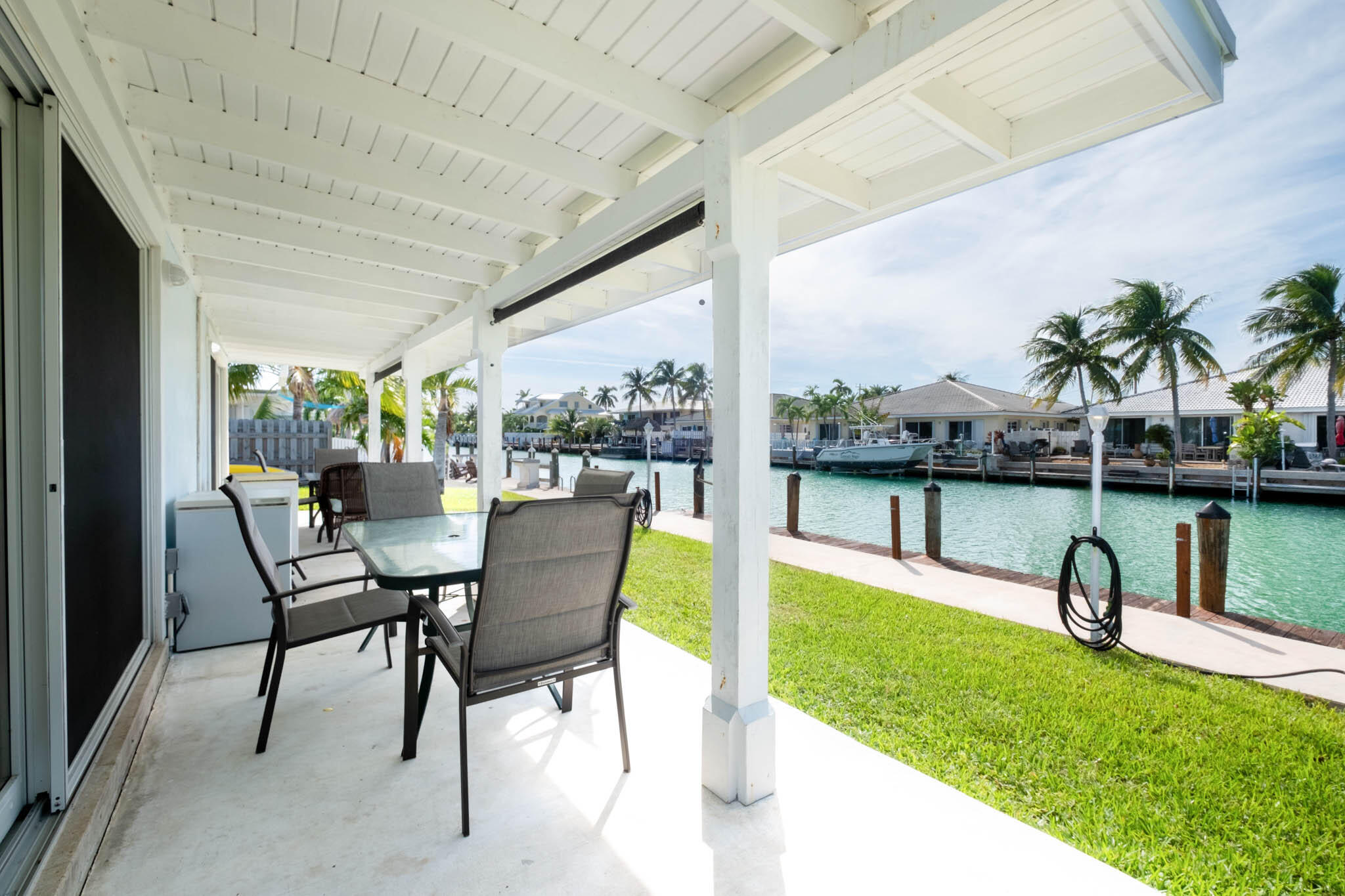271 9th Street Key Colony Beach, FL 33051 - Photo 5 of 48 a view of a swimming pool with a table and chairs