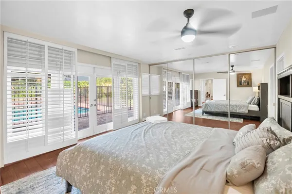 a large bedroom with a large bed and wooden floor