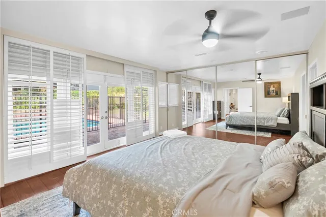 a large bedroom with a large bed and wooden floor