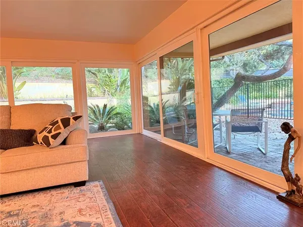 a living room with furniture and large windows
