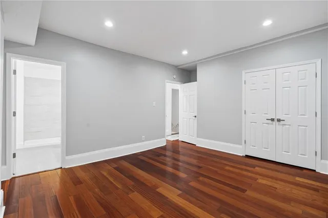 an empty room with wooden floor
