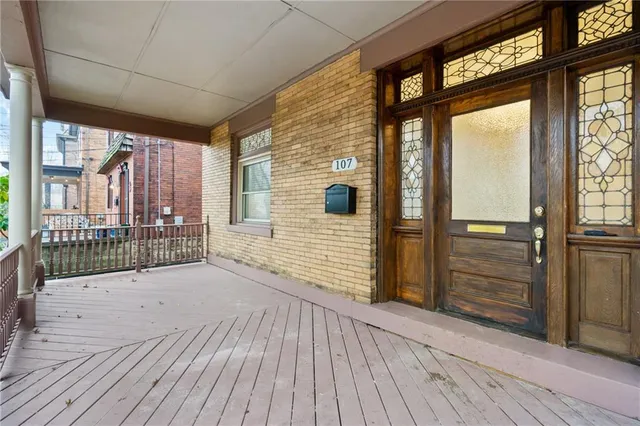 a view of a porch with wooden floor