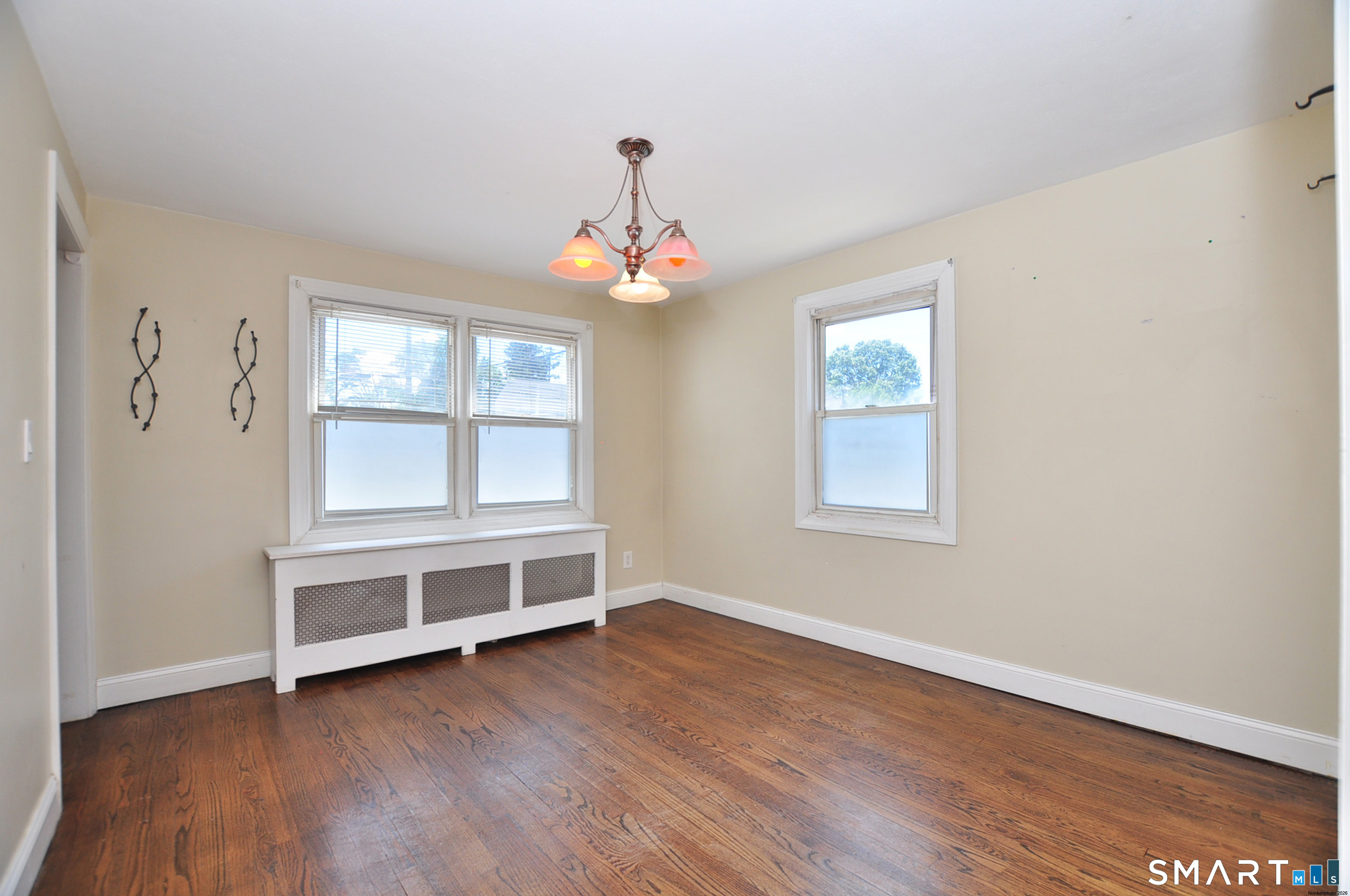 103 West Center Street Manchester, CT 06040 - Photo 12 of 29 wooden floor in an empty room with a window