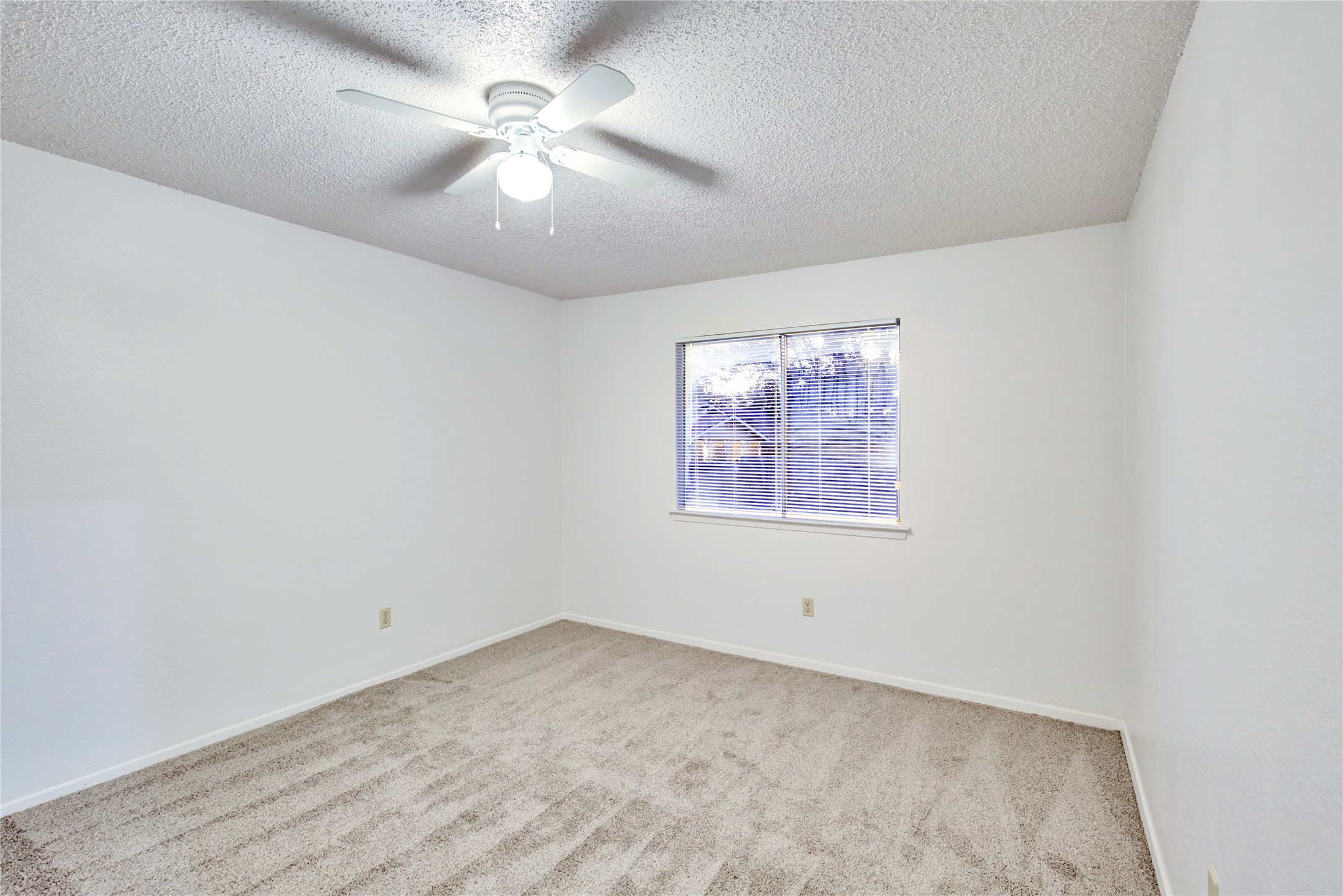 2807 Firecrest Drive Austin, TX 78748 - Photo 11 of 30 an empty room with a ceiling fan and a window