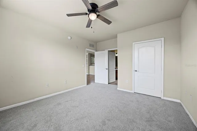 a view of a big room with a ceiling fan and a ceiling fan