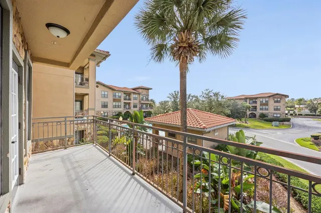 a view of a balcony with wooden chairs