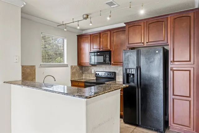 a kitchen with refrigerator a sink and cabinets