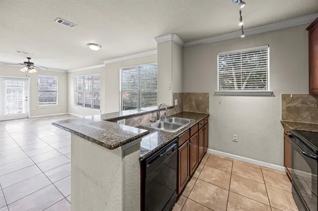 a kitchen with granite countertop a stove and a sink