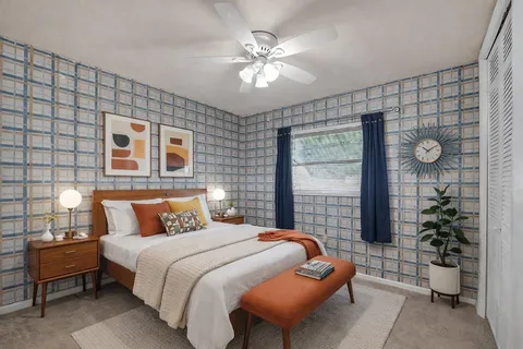 a bedroom with a large bed and a chandelier