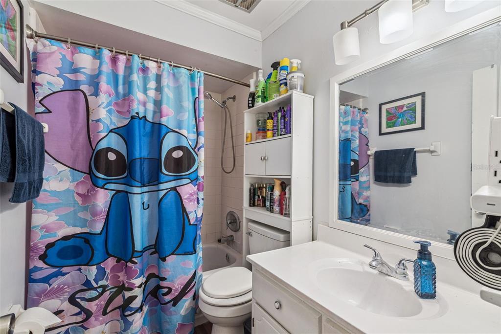 1935 South Conway Road, Unit 6 Orlando, FL 32812 - Photo 19 of 25 a bathroom with a toilet sink and mirror