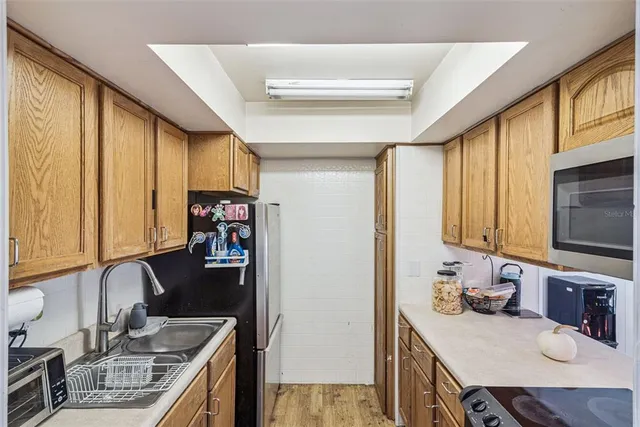 a kitchen with stainless steel appliances granite countertop a sink stove and cabinets
