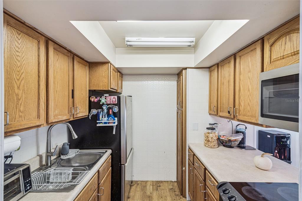 1935 South Conway Road, Unit 6 Orlando, FL 32812 - Photo 8 of 25 a kitchen with stainless steel appliances granite countertop a sink stove and cabinets