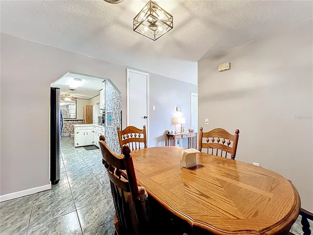 a kitchen that has a lot of cabinets a sink and appliances