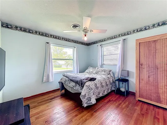 a spacious bedroom with a bed and a chandelier
