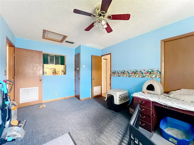a bedroom with furniture and a flat screen tv