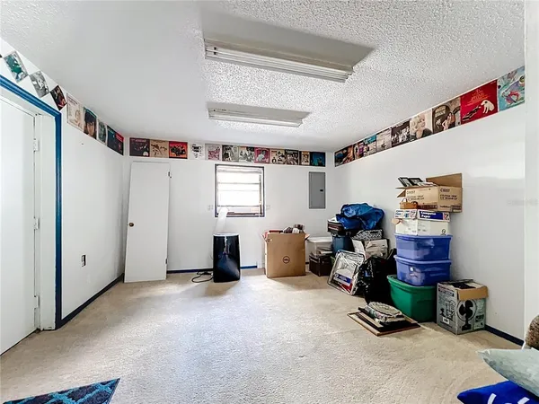 a view of backyard with swimming pool and seating space