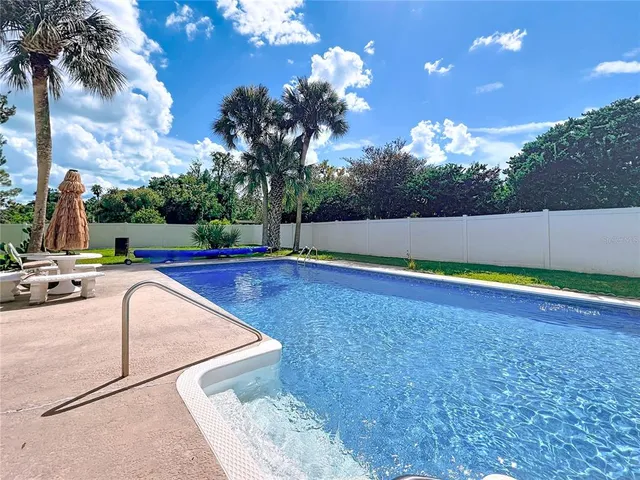 an aerial view of a houses with a yard