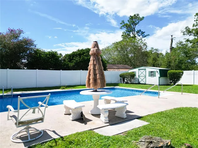 an aerial view of a house with a yard basket ball court and outdoor seating
