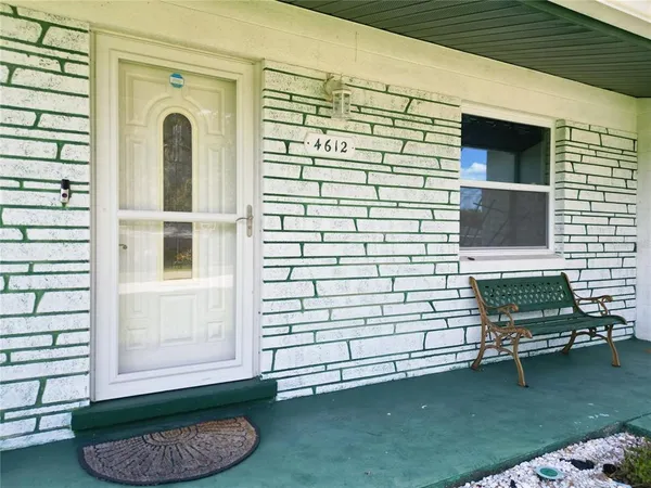 a view of a two chairs in the patio