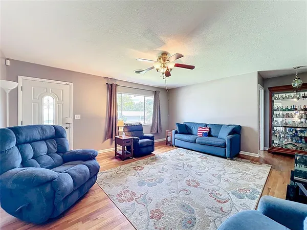 a living room with furniture and a chandelier