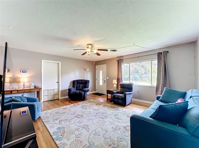 a dining room with furniture and wooden floor