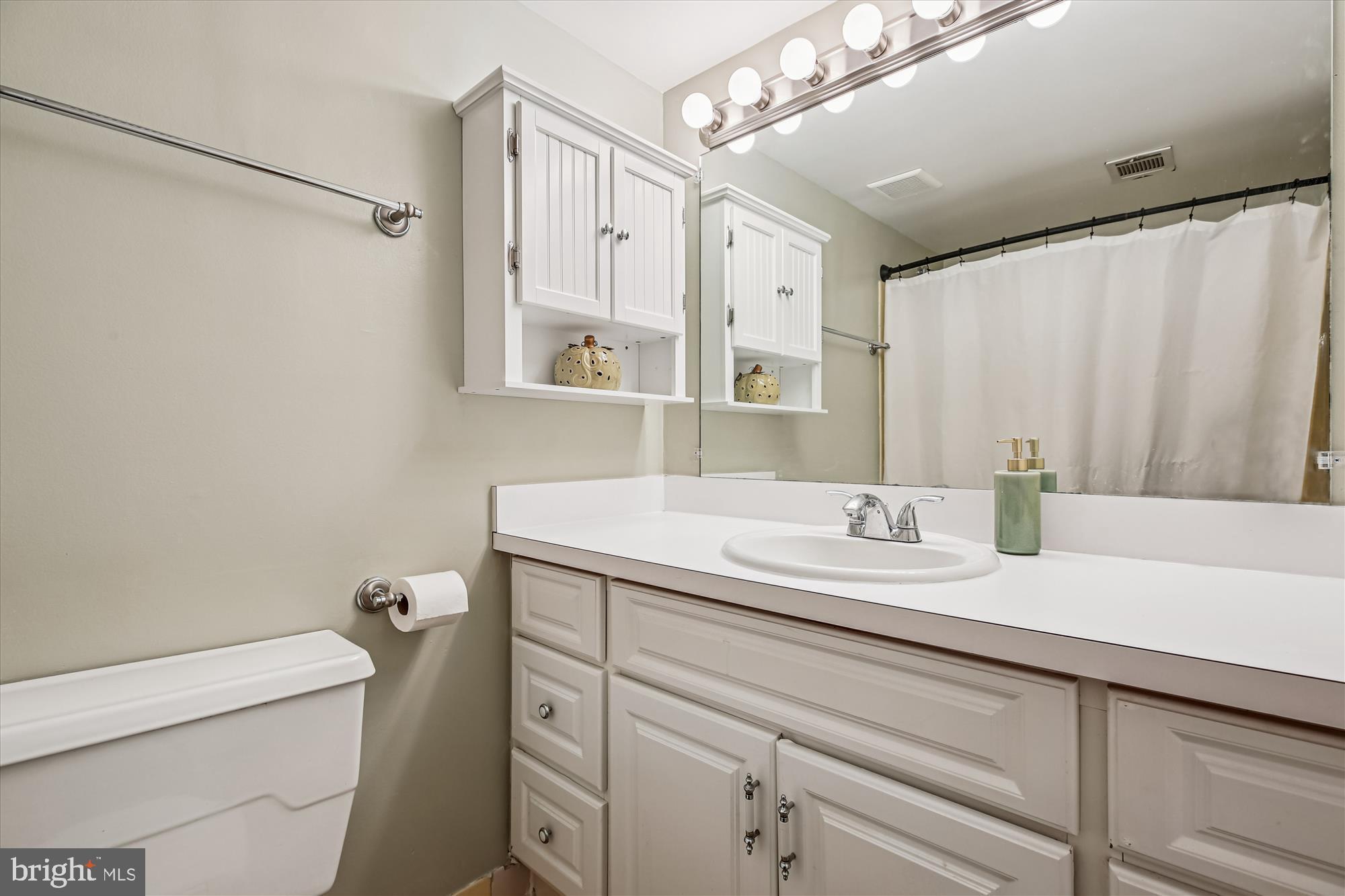 2517 Baltimore Road, Unit 25171 Rockville, MD 20853 - Photo 15 of 35 a bathroom with a granite countertop sink a toilet and a mirror