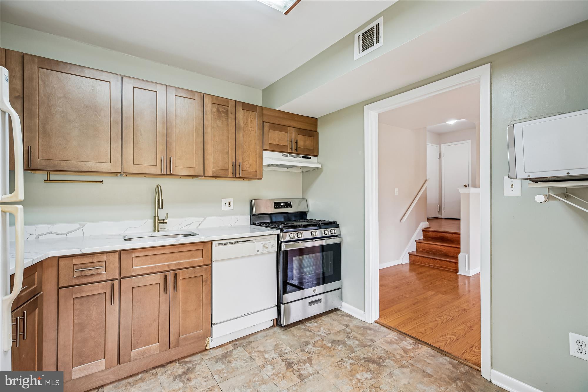 2517 Baltimore Road, Unit 25171 Rockville, MD 20853 - Photo 4 of 35 a kitchen with white cabinets and appliances