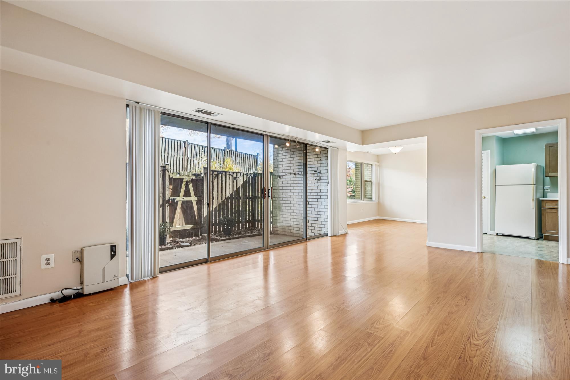 2517 Baltimore Road, Unit 25171 Rockville, MD 20853 - Photo 8 of 35 a view of an empty room with wooden floor and a window