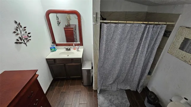 a bathroom with a sink vanity mirror and toilet