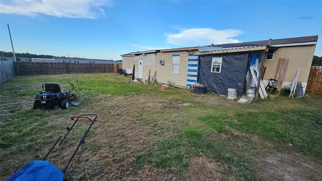 a view of a backyard with plants and a car