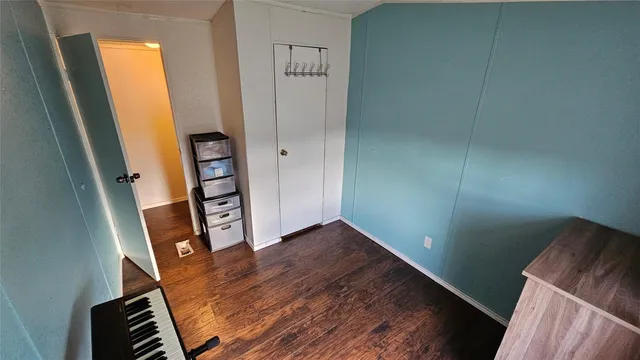 a view of an empty room and wooden floor