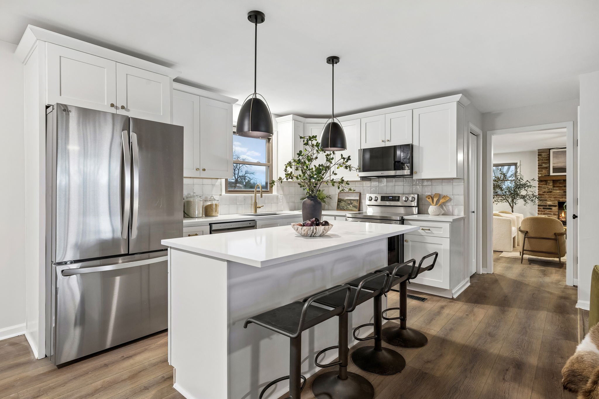 171 New Shackle Island Road Hendersonville, TN 37075 - Photo 6 of 48 a kitchen with kitchen island white cabinets stainless steel appliances and wooden floor