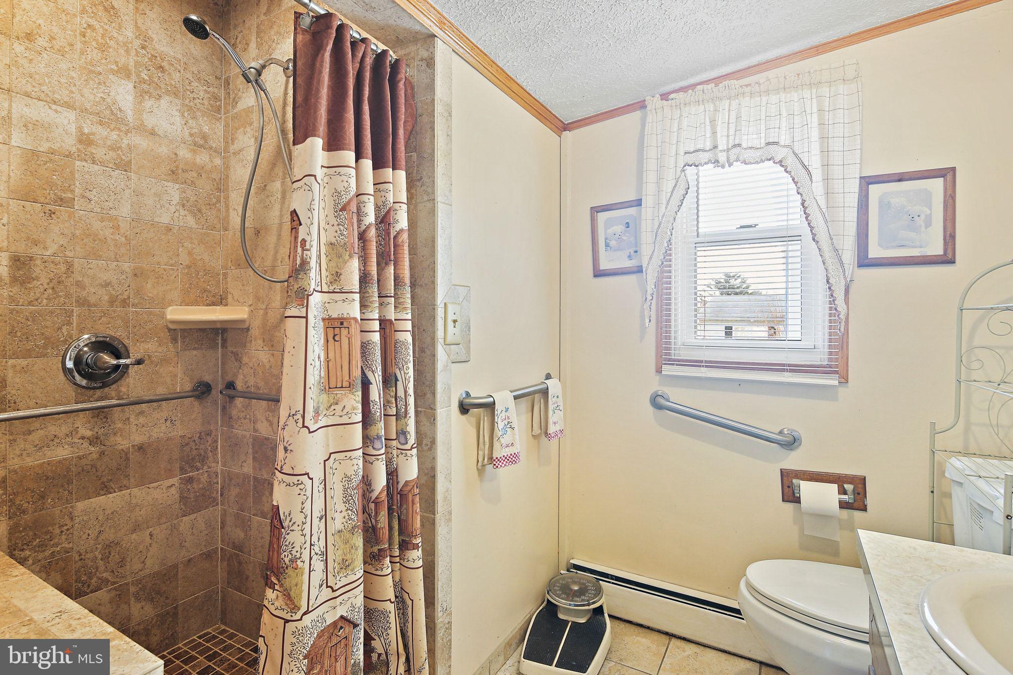 1025 St Michaels Road Mount Airy, MD 21771 - Photo 22 of 31 a white toilet sitting next to a bathroom sink