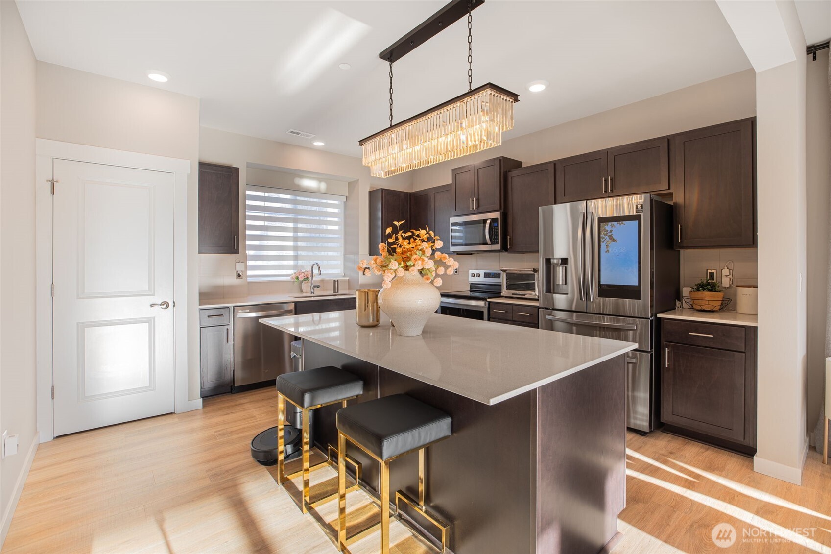 1621 Seattle Hill Road, Unit EE1 Bothell, WA 98012 - Photo 4 of 39 a kitchen with stainless steel appliances kitchen island granite countertop a refrigerator a sink dishwasher a stove and a refrigerator with wooden floor