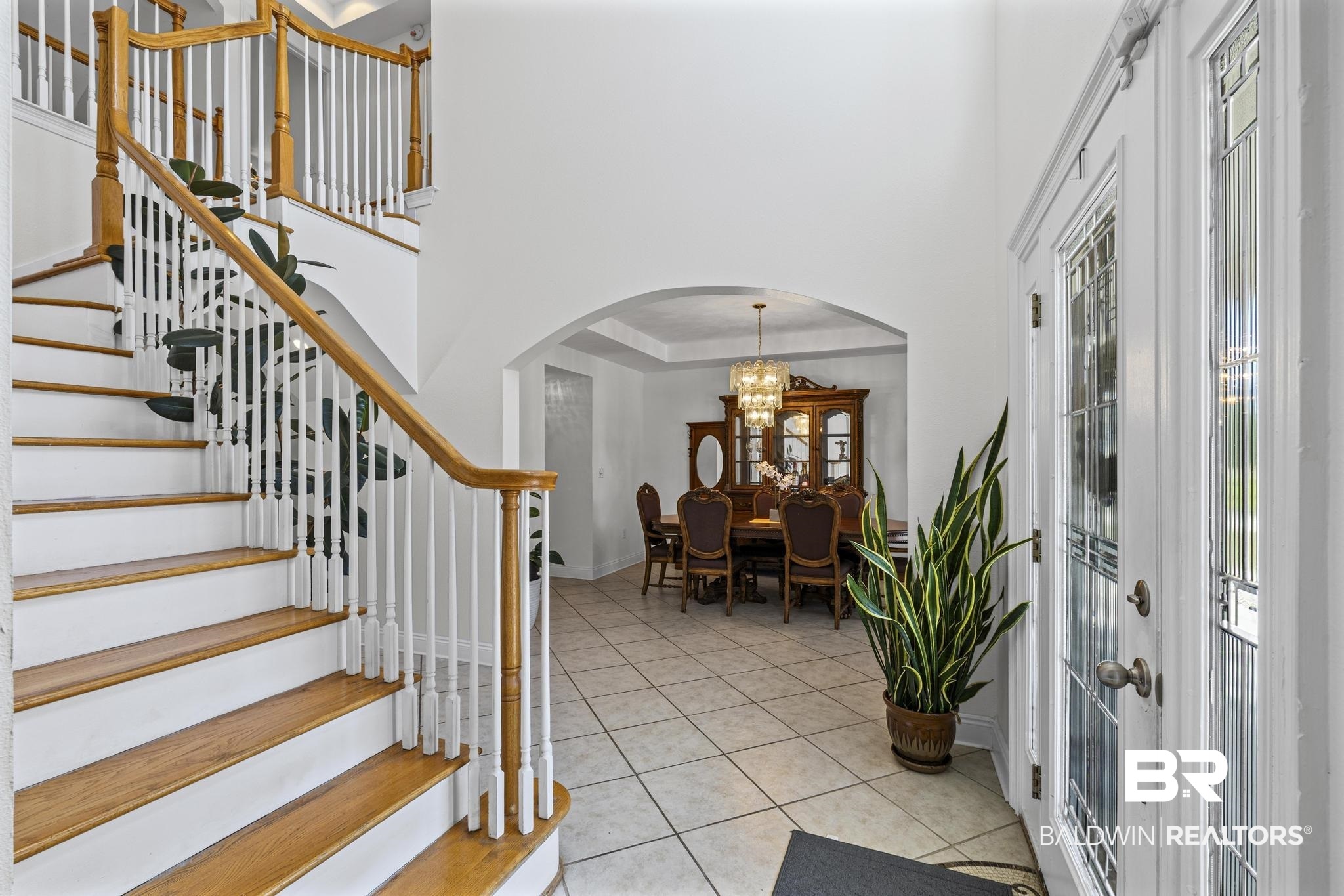 32875 Faircloth Road Lillian, AL 36549 - Photo 14 of 85 Foyer entrance with arched walkways, light tile patterned floors, hanging lights, and a high ceiling