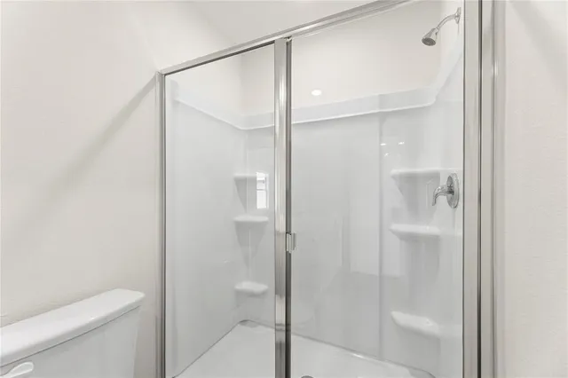 a bathroom with a shower and a toilet