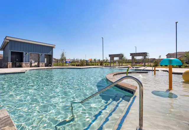a swimming pool with outdoor seating and yard
