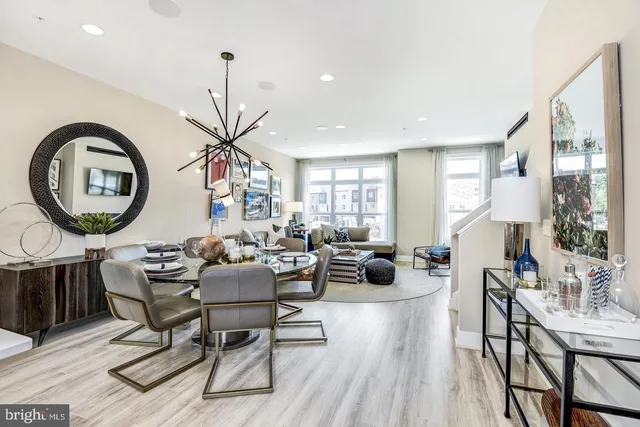 a living room with furniture a mirror a clock and a window