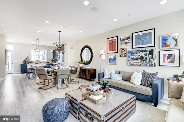 a living room with lots of furniture and a view of kitchen