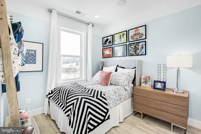 a bedroom with a bed and a painting on the wall