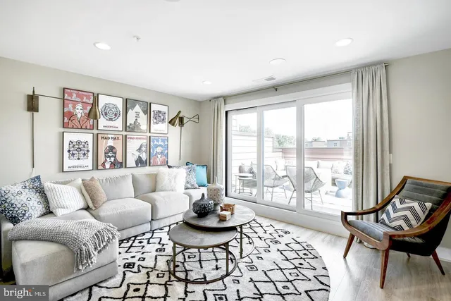 a living room with furniture and a large window