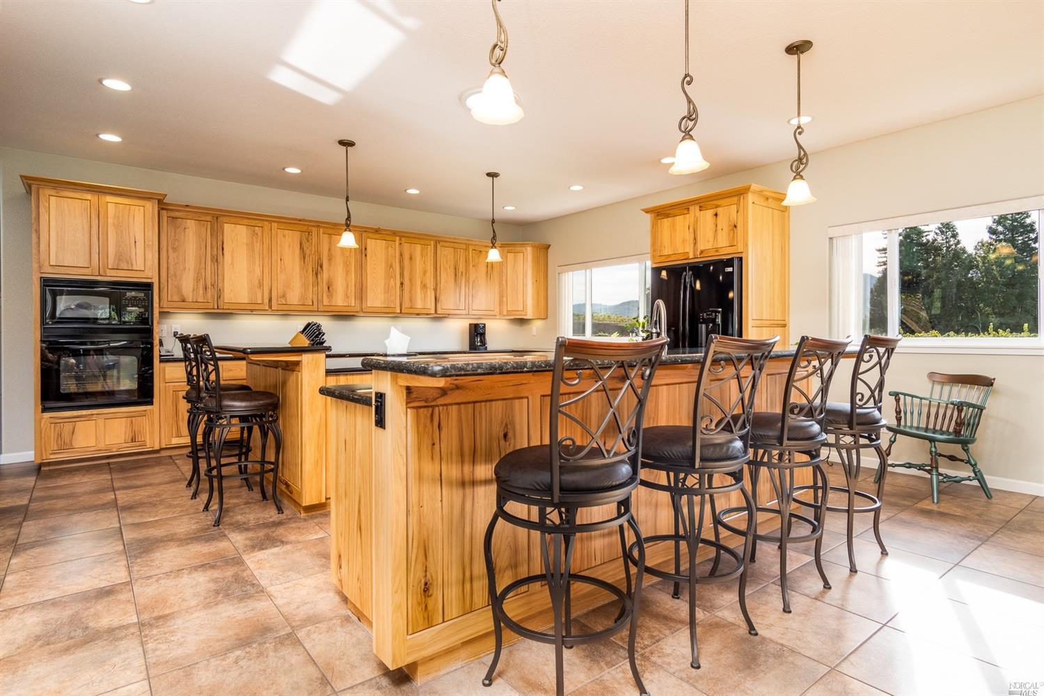 an open kitchen with a table and chairs