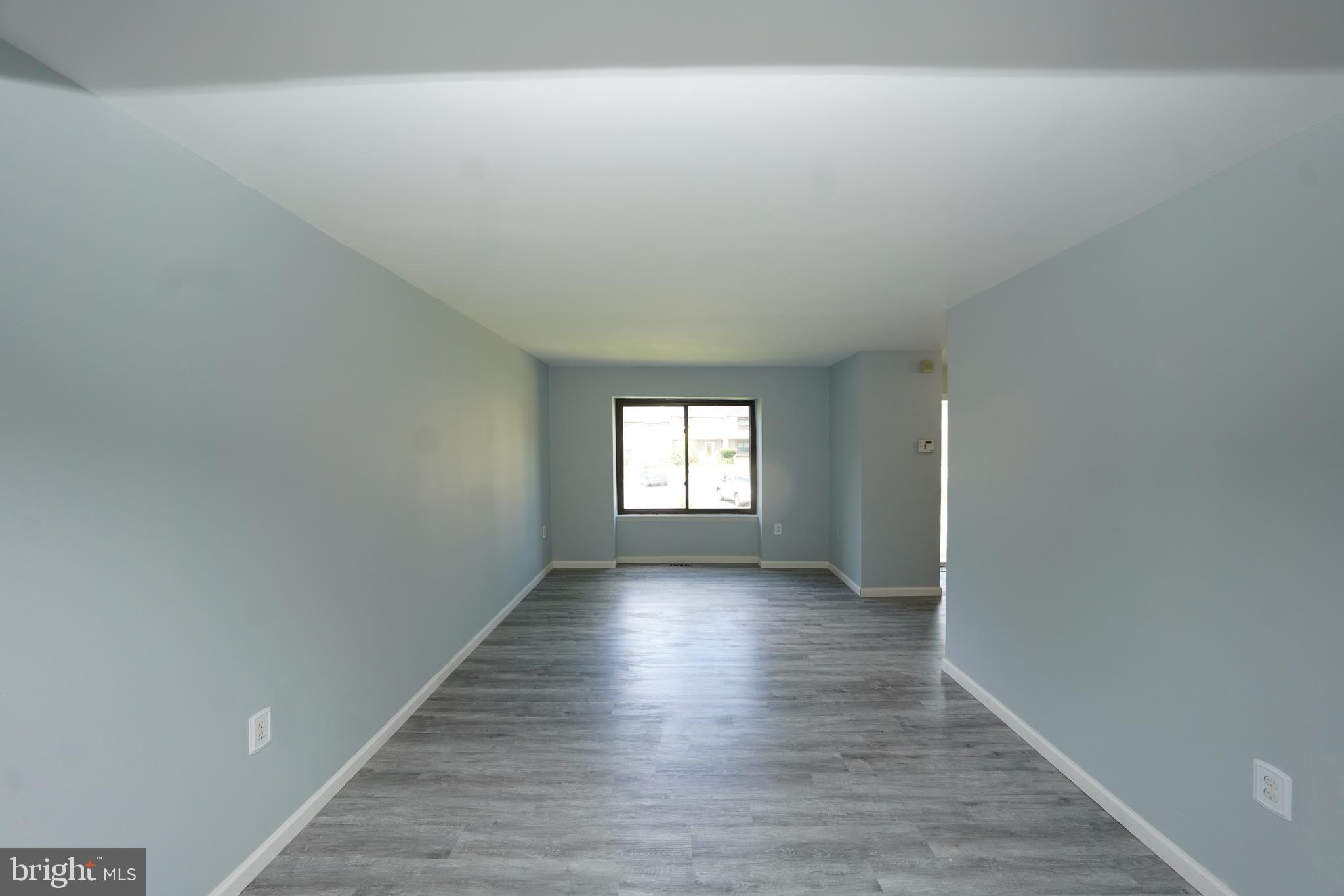 8997 Centerway Road Gaithersburg, MD 20879 - Photo 12 of 71 an empty room with wooden floor and windows