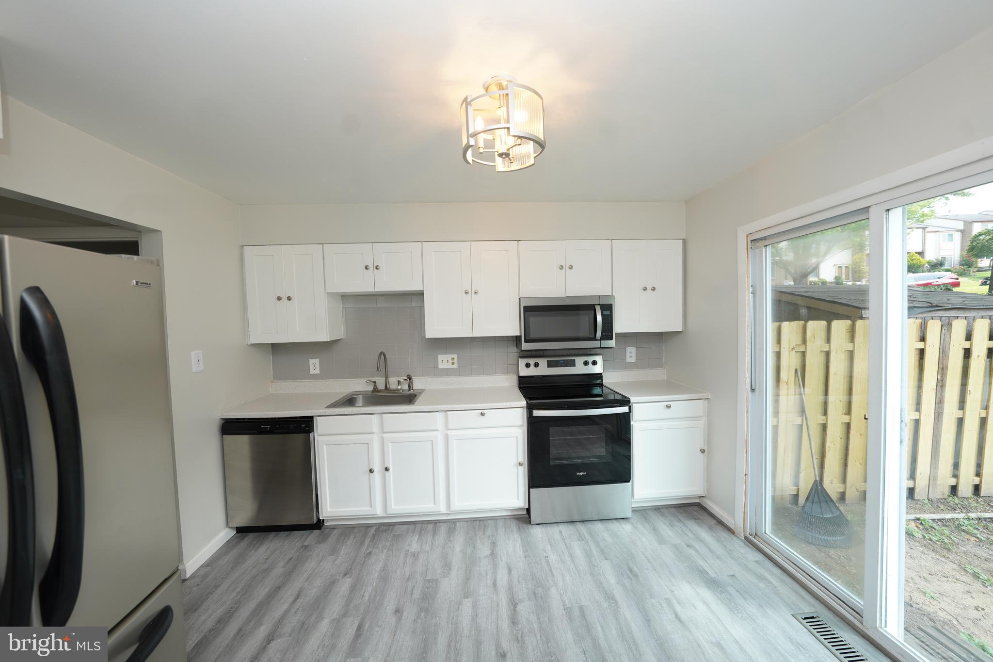 8997 Centerway Road Gaithersburg, MD 20879 - Photo 18 of 71 a kitchen with stainless steel appliances a refrigerator sink and cabinets