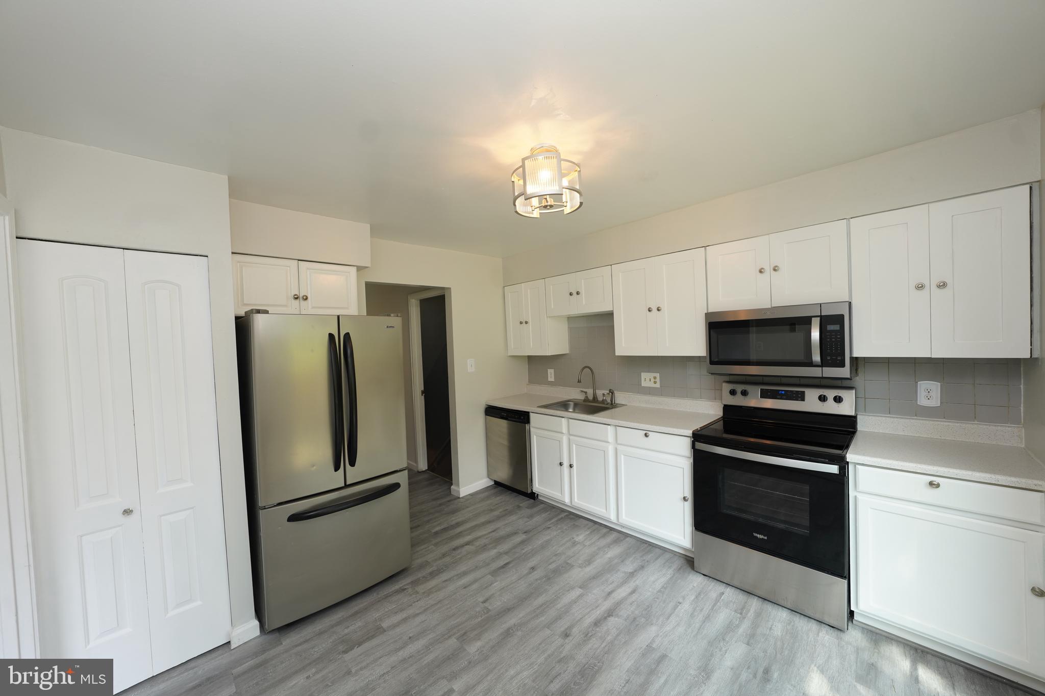 8997 Centerway Road Gaithersburg, MD 20879 - Photo 19 of 71 a kitchen with stainless steel appliances a refrigerator sink and microwave